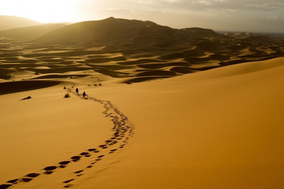 Free Image of Group of People Walking Across a Desert 