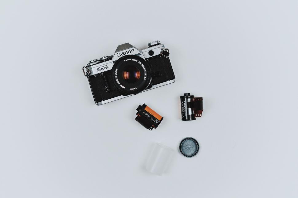 Free Image of Camera and Batteries on White Surface 