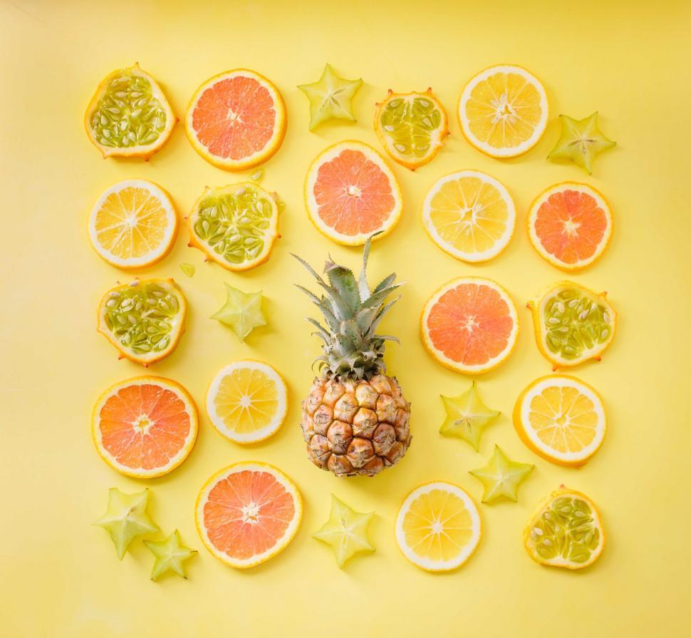 Free Image of Pineapple Surrounded by Cut Citrus Fruits 