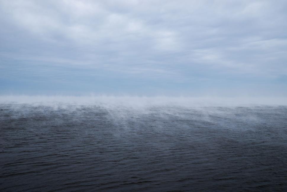 Free Image of Large Body of Water Under Cloudy Sky 
