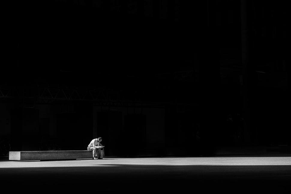 Free Image of Person Sitting on Bench in Black and White 