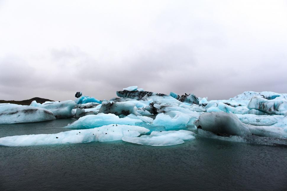 Free Image of Group of Icebergs Floating on Top of a Body of Water 