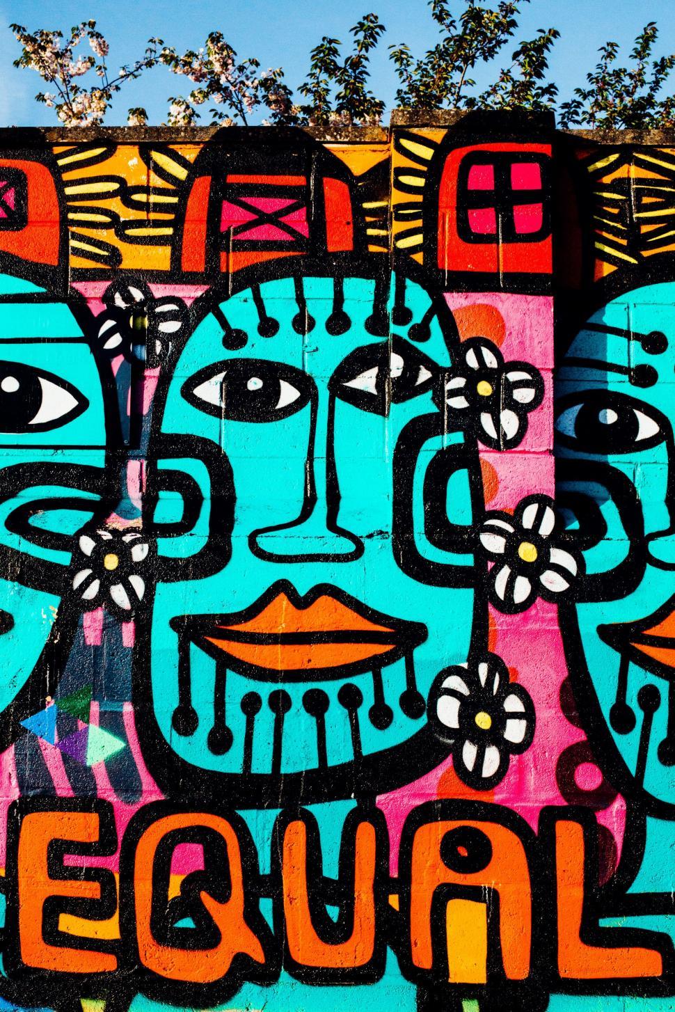 Free Image of Colorful Wall With Painted Faces 