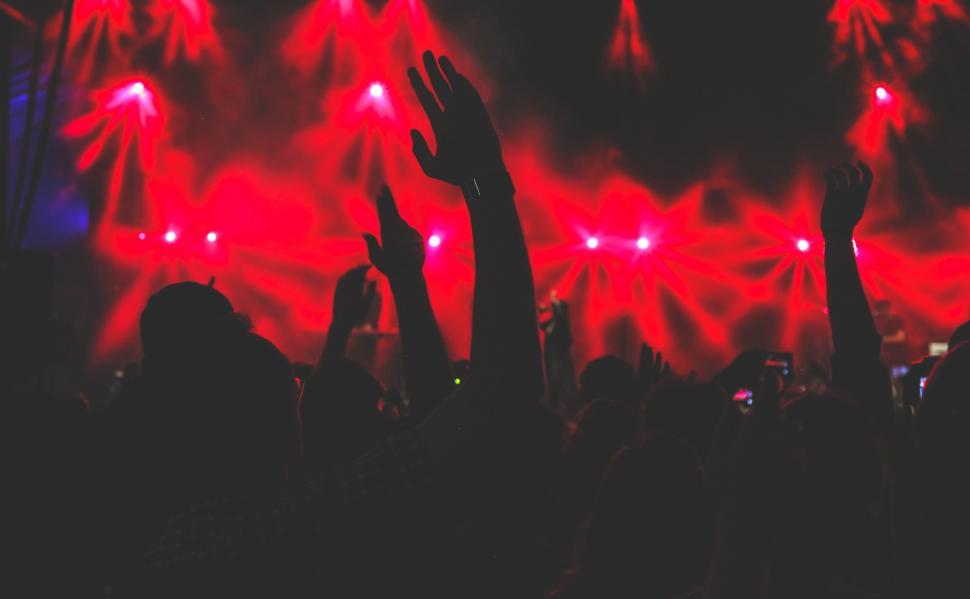 Free Image of Excited Crowd Raises Hands at Concert 