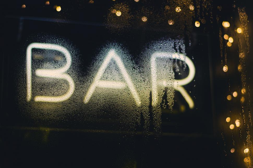 Free Image of Close Up of Bar Sign on Window 