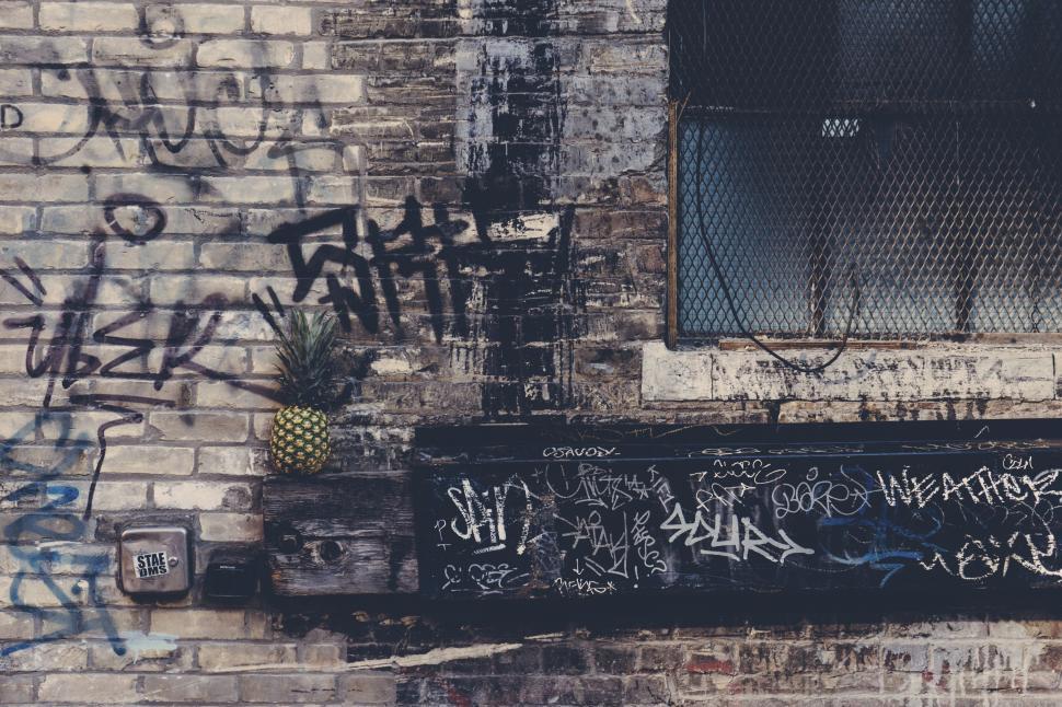 Free Image of Brick Wall With Graffiti and Window 