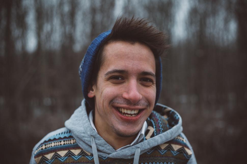 Free Image of Smiling Man in Blue and White Sweater 