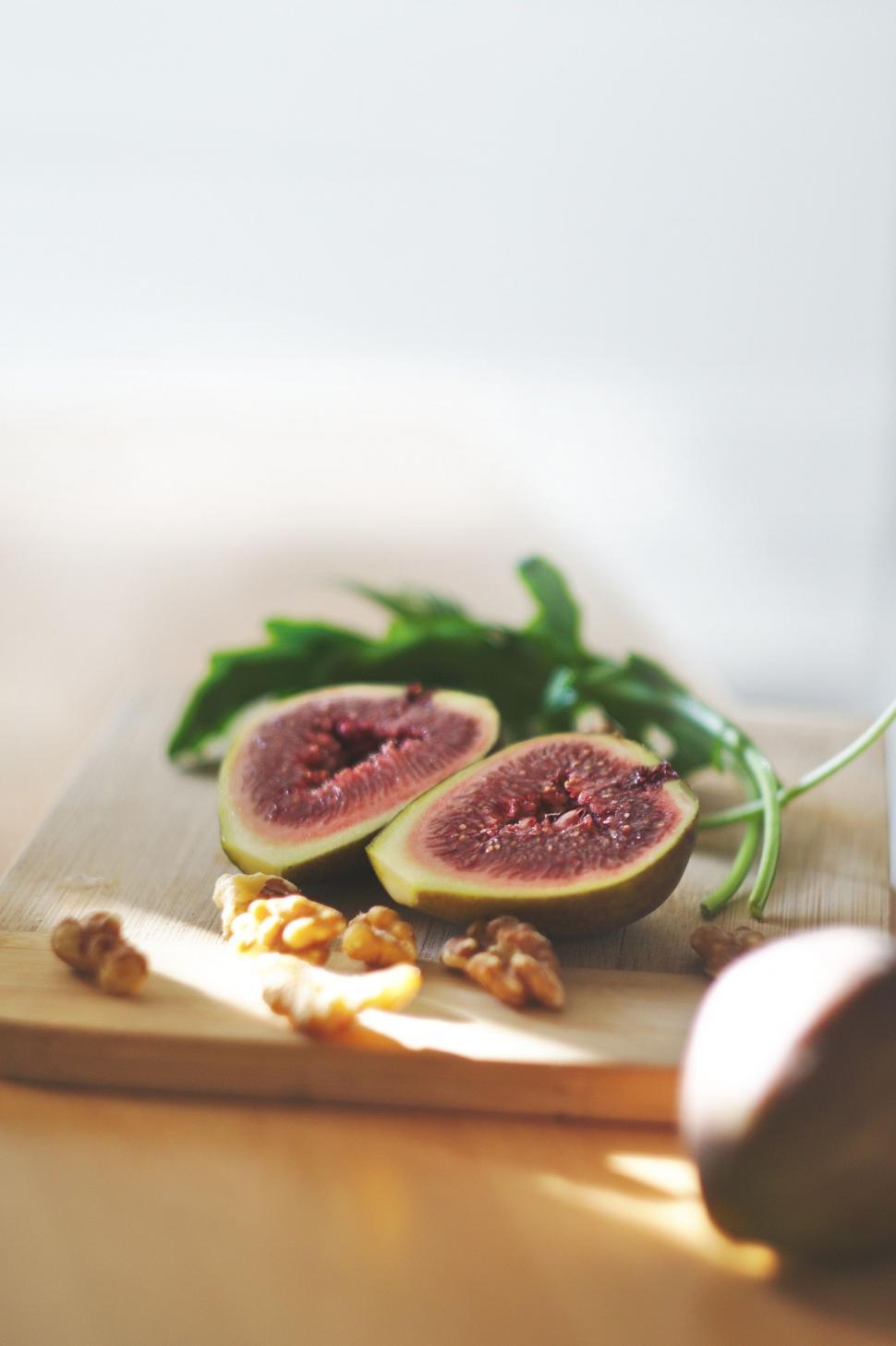 Free Image of Wooden Cutting Board With Figs and Nuts 