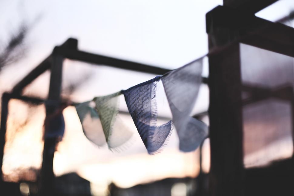 Free Image of Group of Flags Hanging From Wooden Pole 