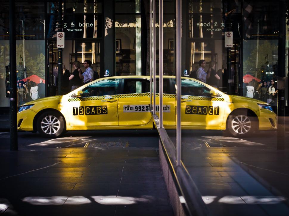 Free Image of Yellow Taxi Cab Parked in Front of Building 