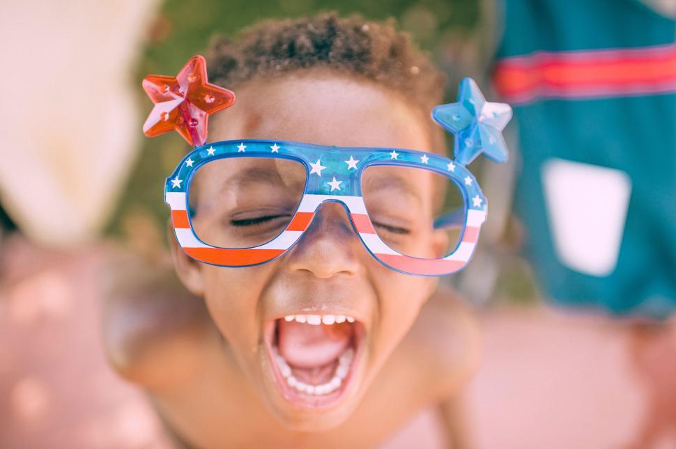 Free Image of Young Boy Wearing Patriotic Glasses With Mouth Open 