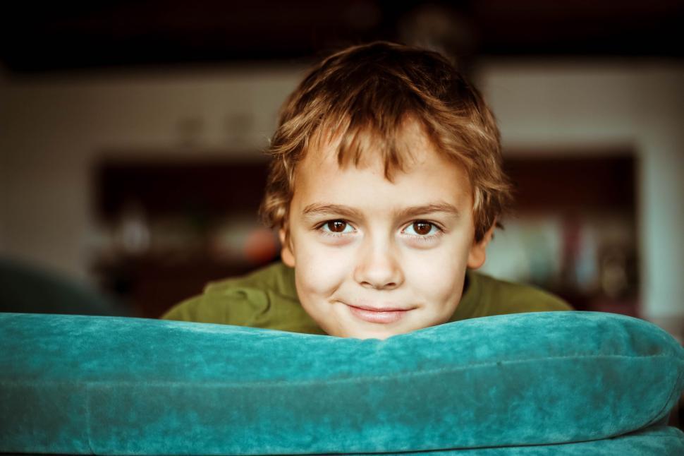 Free Image of Young Boy Sitting in Green Chair 