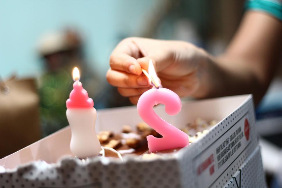 Free Image of Person Lighting Candles on a Birthday Cake 