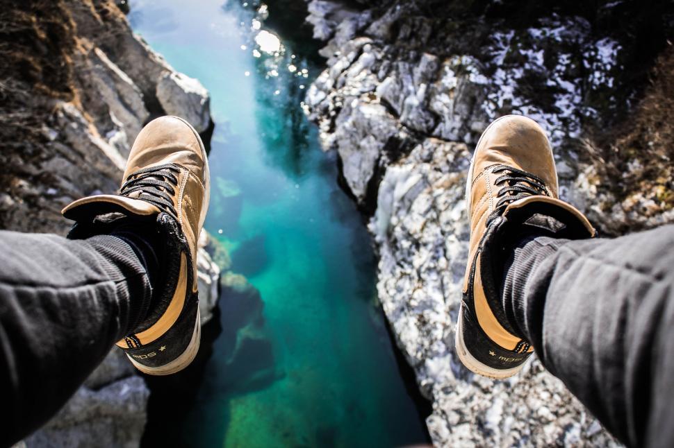 Free Image of Person Standing on Cliff by River 