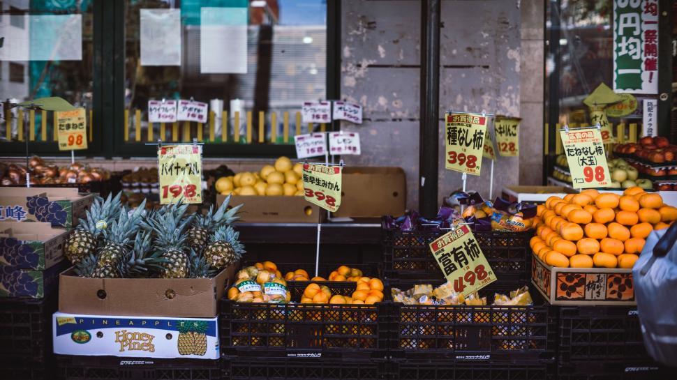 Free Image of Fresh Fruit Stand Displaying Oranges, Pineapples, and Pineapples 