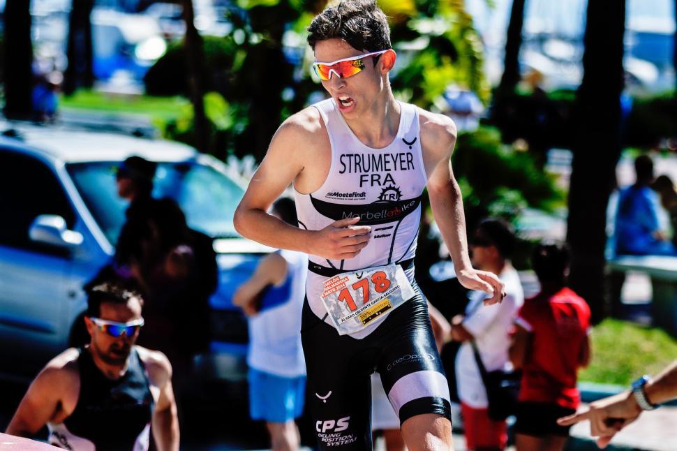Free Image of Man in a Triathlon Suit Running in a Race 