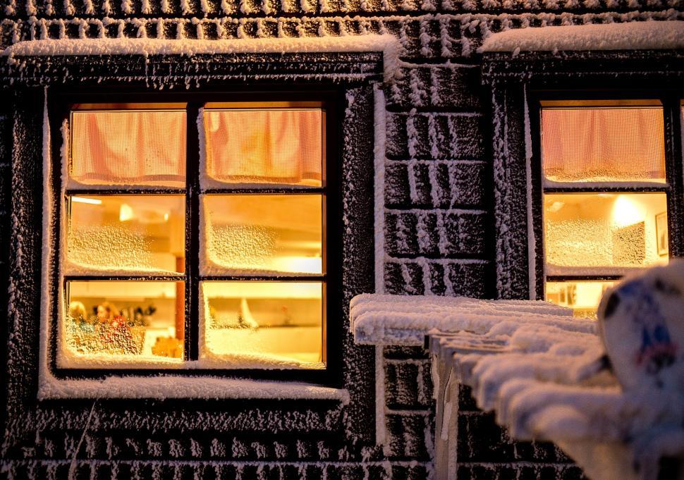 Free Image of Snow Covered Building With Two Windows and Bench 