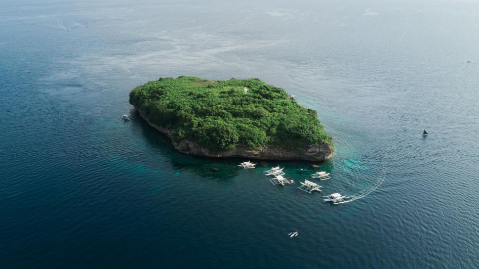 Free Image of A Small Island in the Middle of a Body of Water 
