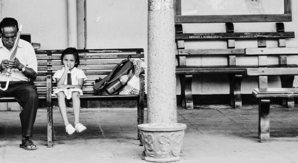 Free Image of Man Sitting on Bench Next to Little Girl 