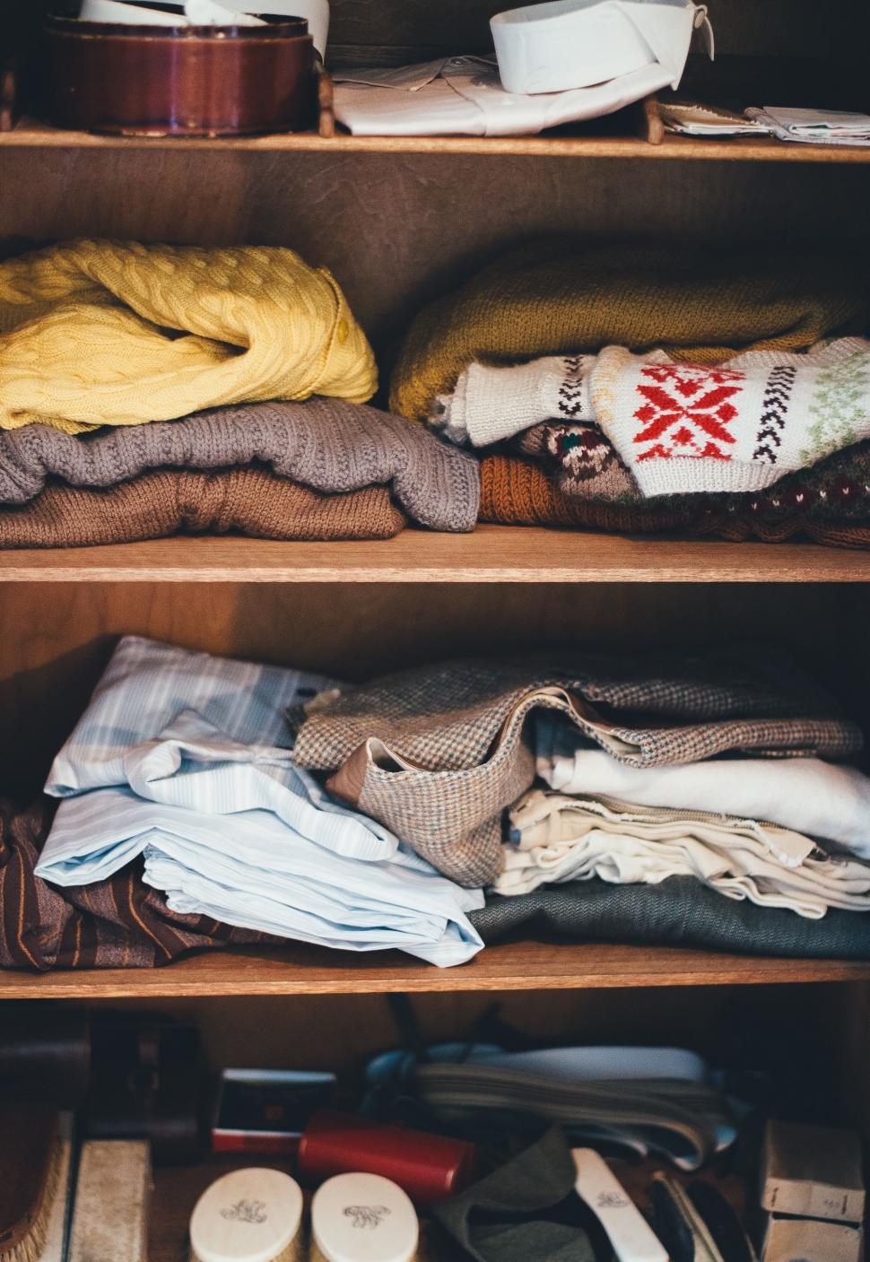 Free Image of Wooden Shelf Filled With Clothes 