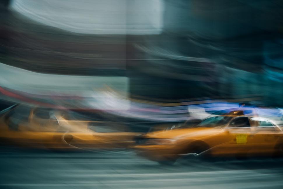 Free Image of Blurry Picture of a Taxi Cab in the Rain 