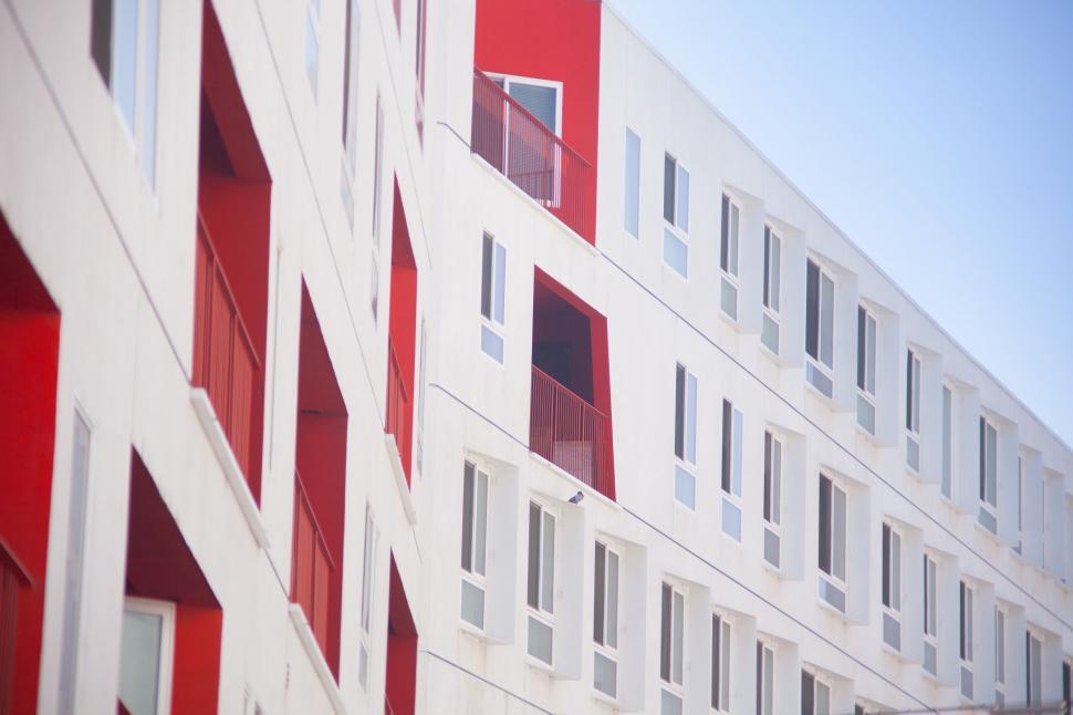 Free Image of Red and White Building With Many Windows 