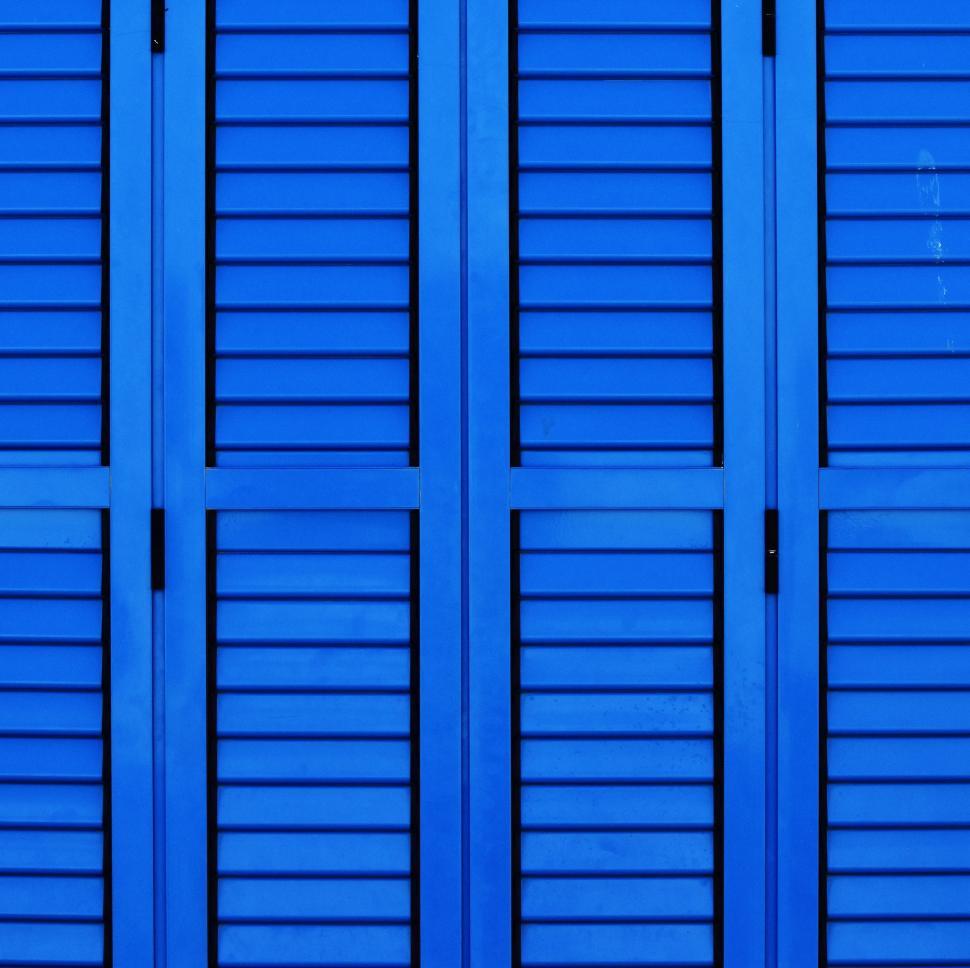 Free Image of Close Up of a Blue Wall With Shutters 