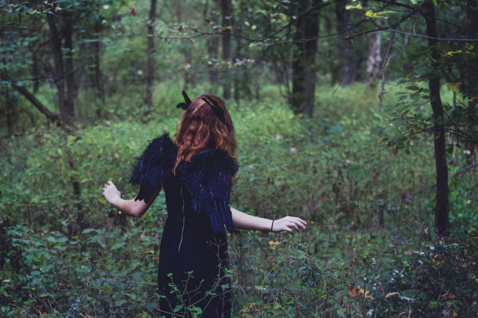 Free Image of Woman in Black Dress Standing in Forest 