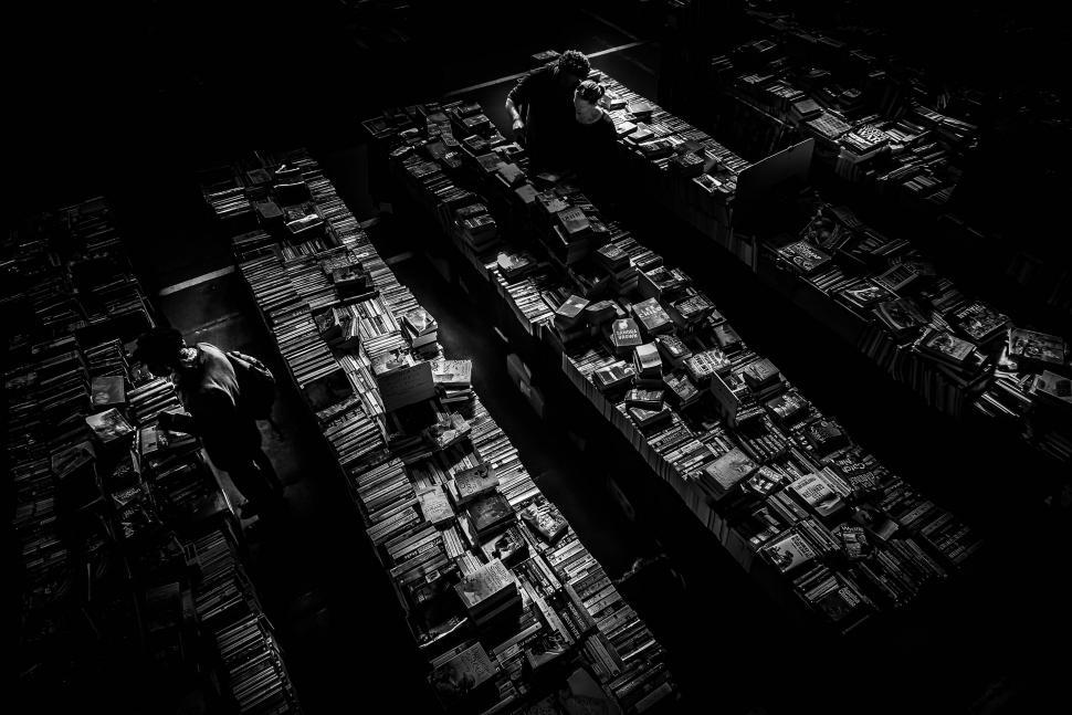 Free Image of Man Standing in Room Filled With Boxes 