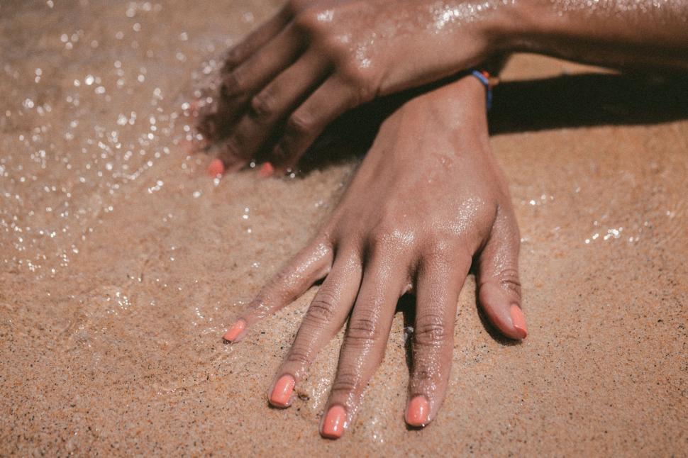 Free Image of Hand Covered in Sand 