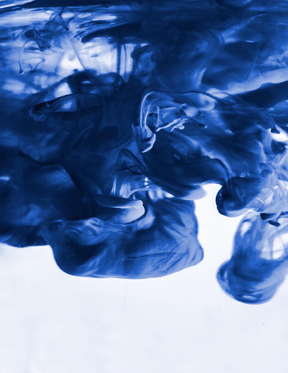 Free Image of Blue Substance Floating in Water on White Surface 