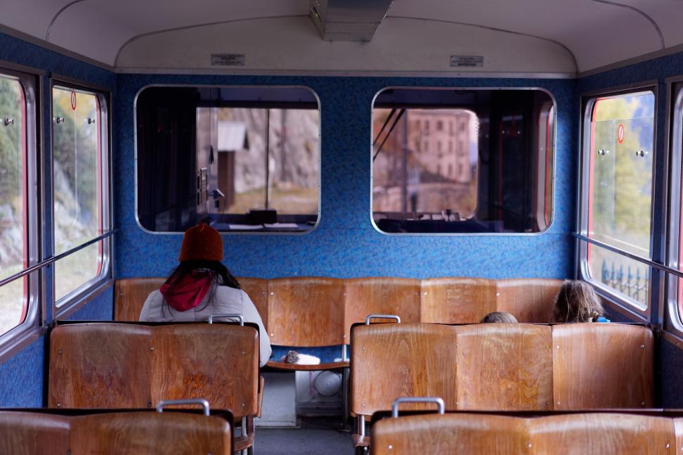 Free Image of Person Sitting in Train Car Looking Out Window 