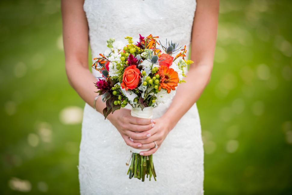 Free Image of Woman in White Dress Holding Bouquet of Flowers 