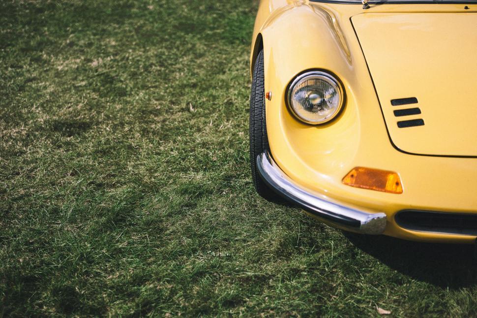 Free Image of Yellow Sports Car Parked in Grassy Field 