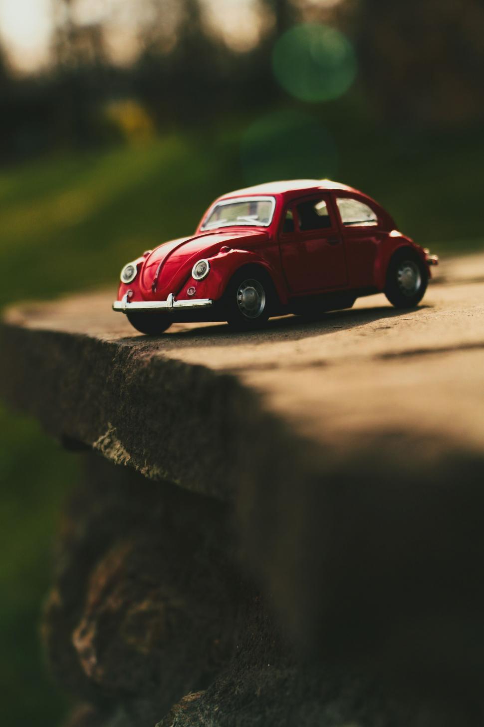 Free Image of Small Red Car on Cement Slab 