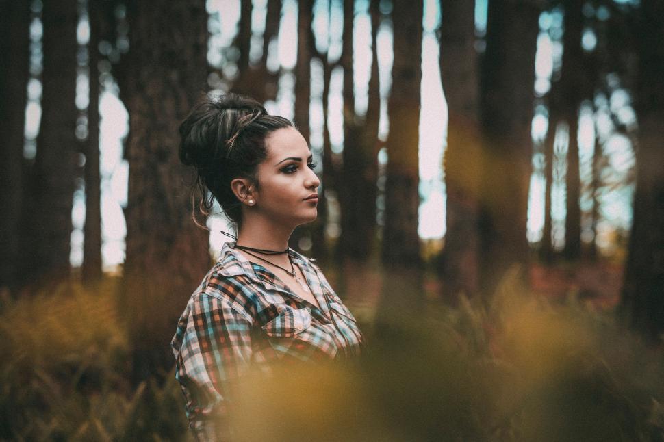 Free Image of Woman in Plaid Shirt Standing in Forest 