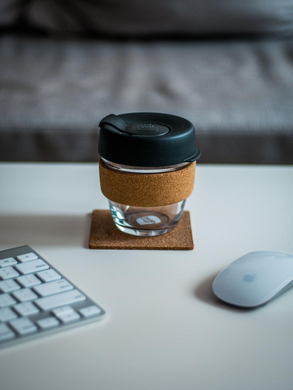 Free Image of Coffee Cup on Coaster Next to Keyboard 