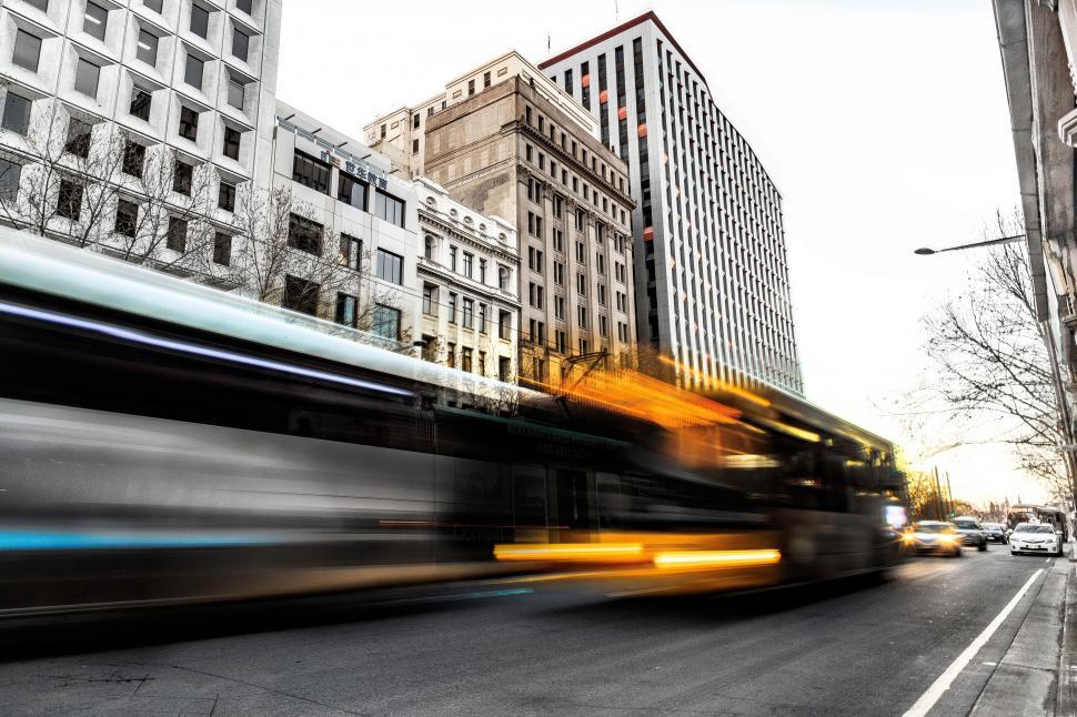Free Image of Blurry Image of a Bus Driving Down a Street 