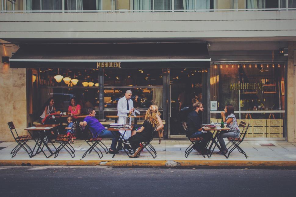 Free Image of Group of People Dining Outside a Restaurant 