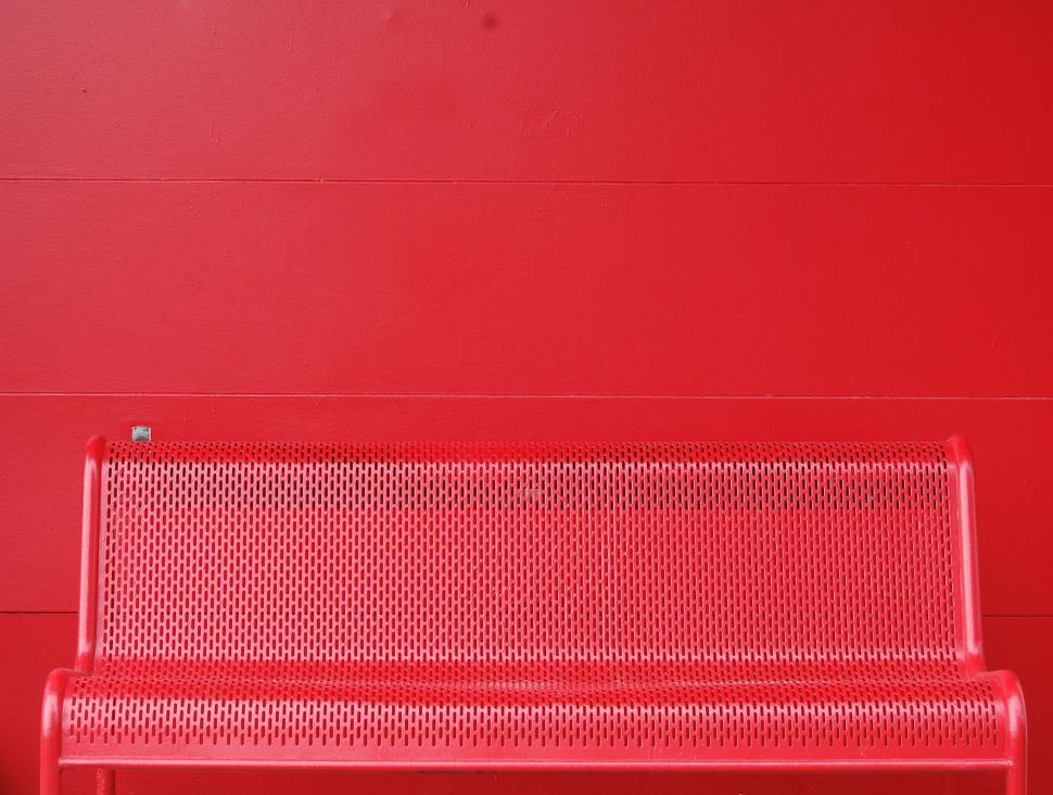 Free Image of Red Metal Bench Against Red Wall 