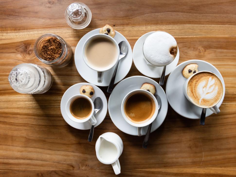 Free Image of Group of Coffee Cups on Wooden Table 
