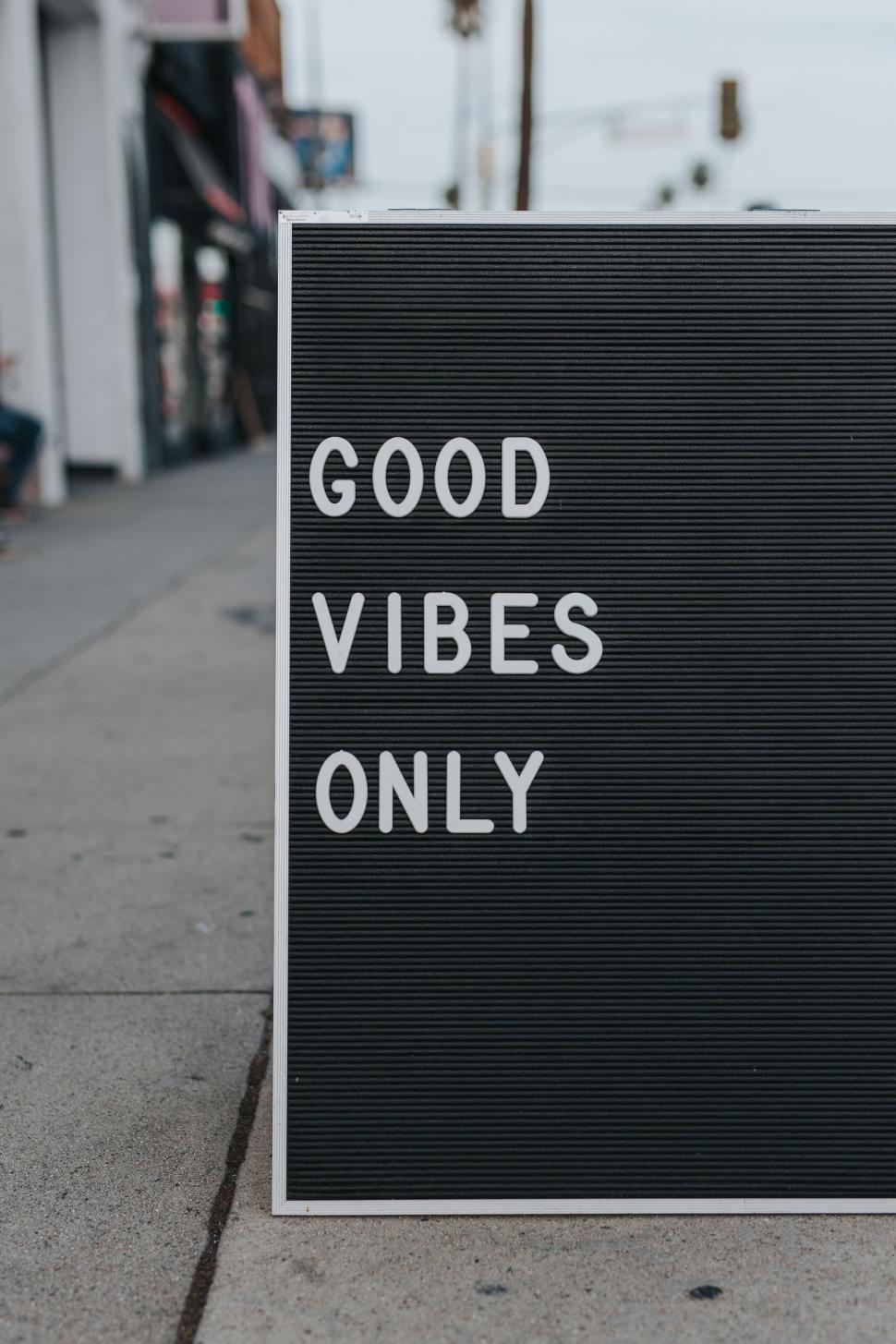 Free Image of Good Vibes Only Sign on Sidewalk 