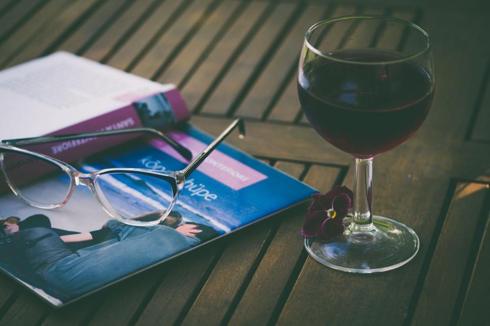 Free Image of Glass of Wine and Book on Table 
