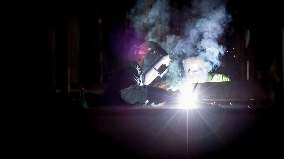 Free Image of Man Welding in the Dark at Night 