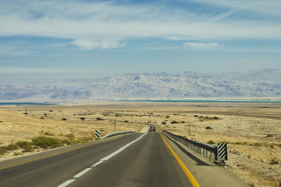 Free Image of Endless Road Cutting Through Desert Landscape 
