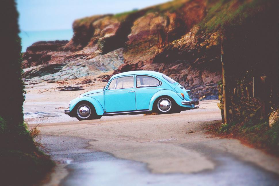 Free Image of Small Blue Car Parked on Roadside 