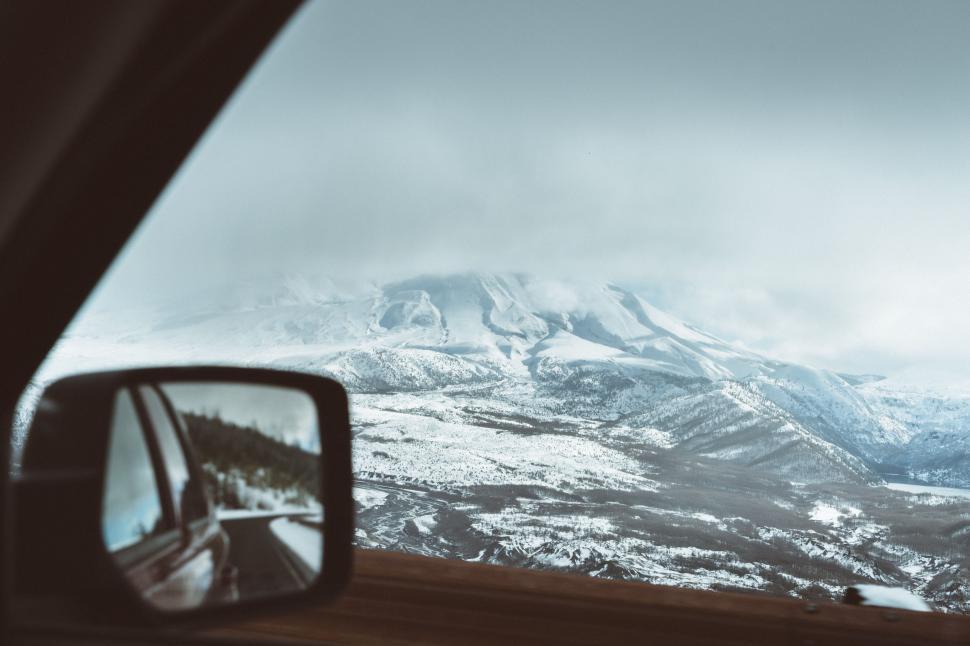 Free Image of Snow Covered Mountain View From Inside Car 