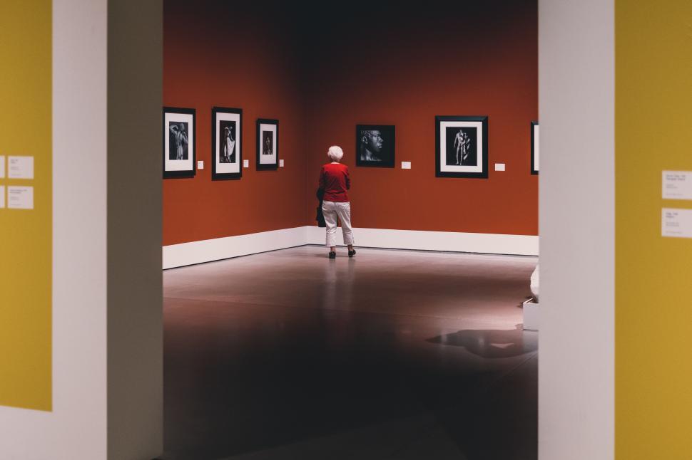 Free Image of Person Standing in Room With Pictures on Walls 