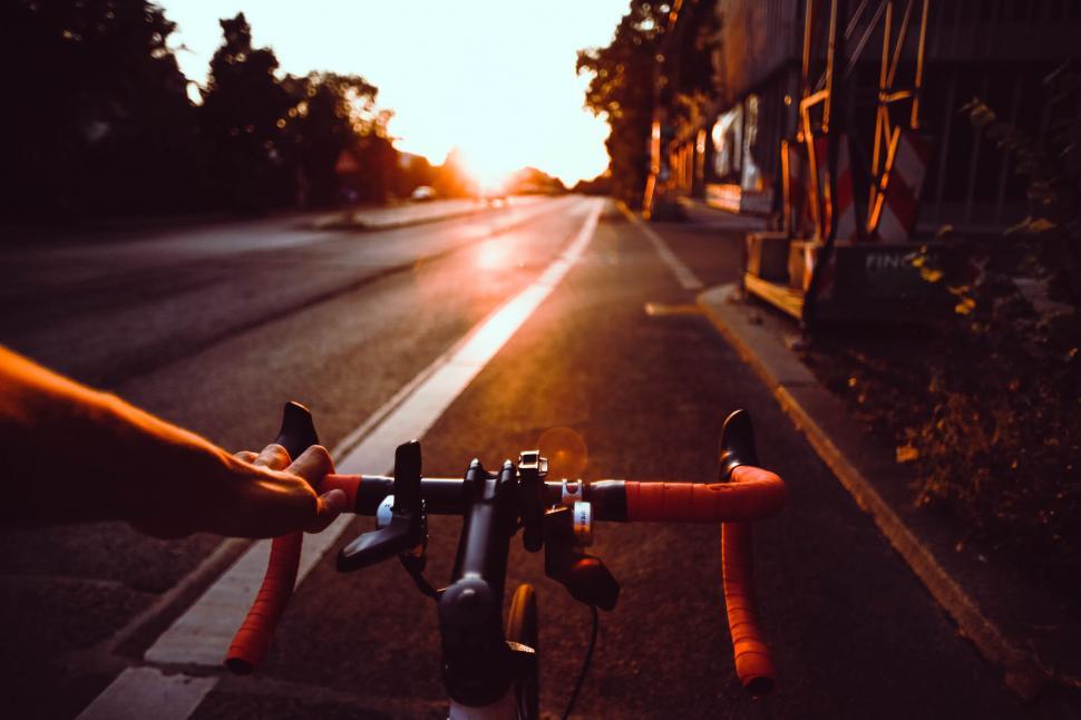 Free Image of Person Holding Bike on Side of Road 