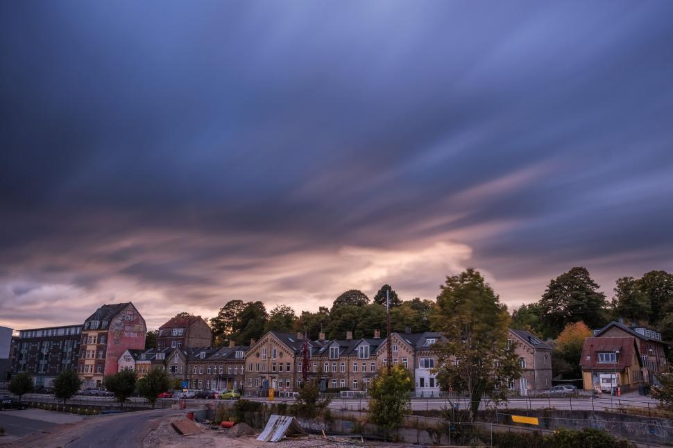 Free Image of Cloudy Sky Over Row of Houses 